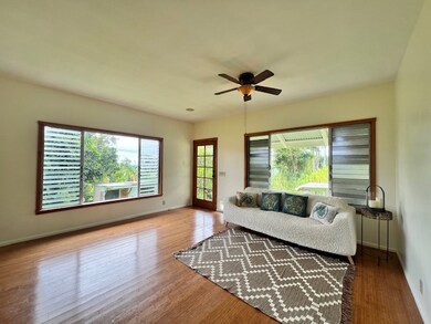 large open living concept with views of Hilo, the sunrise, reverse sunsets, even views of the ocean between the mature old growth trees.