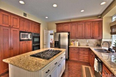 Kitchen: cream toned island cabinets, warm wood ca
