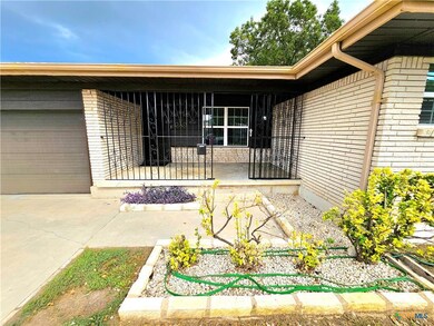 View of exterior entry featuring brick siding, an