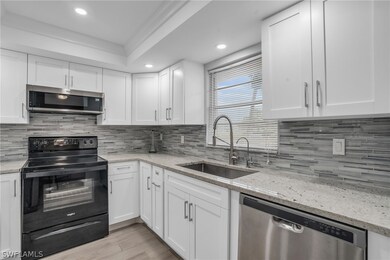 Kitchen with backsplash, appliances with stainless
