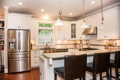 Beautiful kitchen with custom cabinets, hooded gas