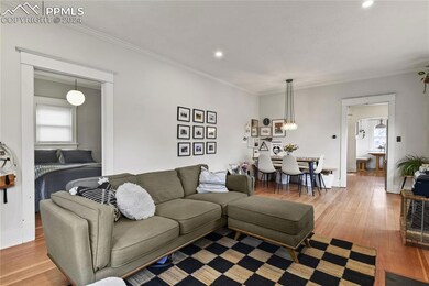 Living room featuring hardwood floors, and a wealt