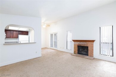 Unfurnished living room with a ceiling fan, arched