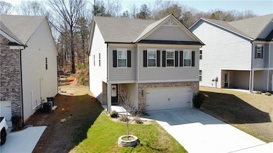 View of front of home with an attached garage, bri