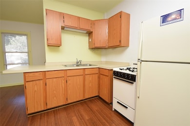 Kitchen with crown molding, a sink, white applian