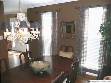 Polished hardwood floors, crown molding, a crystal