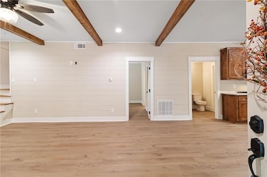 living room featuring light wood-style flooring, wood walls, a ceiling fan, beam ceiling, and recessed lighting
