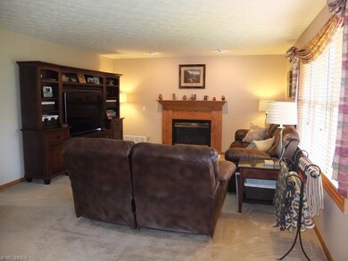 Family room with gas fireplace open to the kitchen