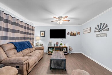 Living room featuring ceiling fan, dark hardwood /
