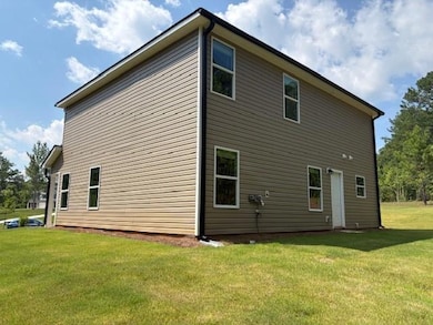 Back of house with a lawn