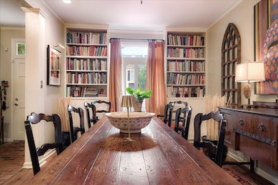 Dining area featuring built in shelves, plenty of natural light, and crown molding