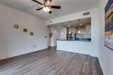 Unfurnished living room with ceiling fan and light