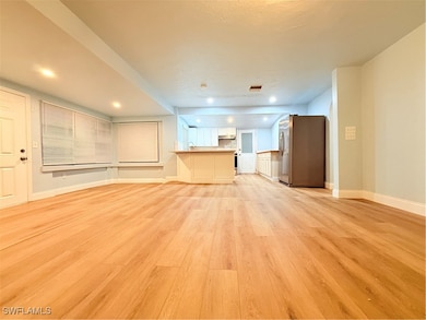 Unfurnished living room featuring light wood-type