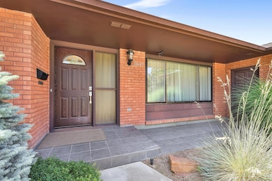View of exterior entry featuring brick siding