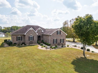 Beautiful, curbed landscaping around the home with front sidewalk leading to driveway.