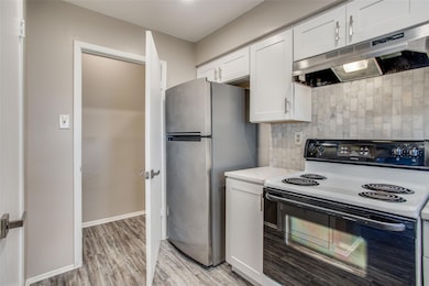 Kitchen featuring electric range oven, under cabi