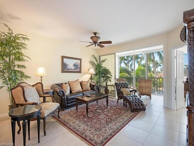 Living room with ceiling fan and light tile patterned floors