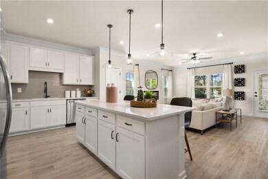 Kitchen with crown molding, backsplash, a sink, li