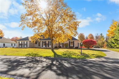 View of front of property with brick siding and a front lawn