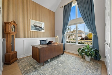 Tall windows frame the office perfectly, offering a front-row view of the neighborhood while filling the room with sunshine.