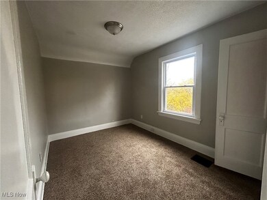 Additional living space with carpet floors, a textured ceiling, and lofted ceiling