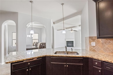 Kitchen with beam ceiling, sink, tasteful backspla