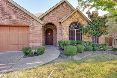 View of front of house with brick siding and an attached garage
