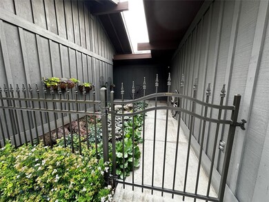 Iron fence and gate going into front entry