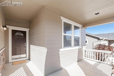 View of exterior entry with covered porch