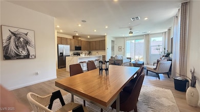 Dining room featuring light wood-style floors, cei
