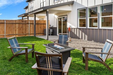 View of yard with an outdoor fire pit, a patio are