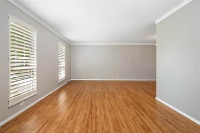 Living Room - fresh paint, newly refinished hardwood floors, crown molding and plantation shutters