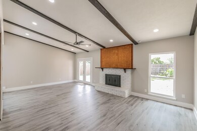 Unfurnished living room with beamed ceiling, ceili