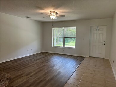 Large living room with back door onto patio