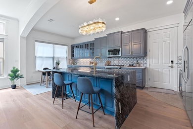 Kitchen featuring crown molding, light wood finis