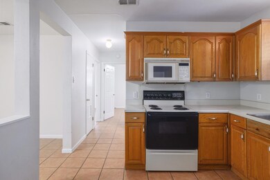 Kitchen featuring white microwave, electric stove