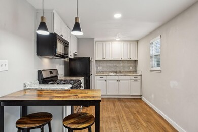 Kitchen with white cabinetry, butcher block counte