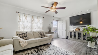 Living room with ceiling fan and wood finished floors