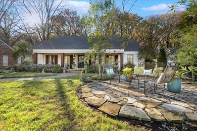 Back of property with covered porch, an outdoor ha