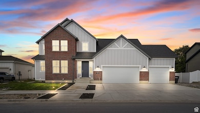View of front of home with board and batten siding, driveway, and a garage