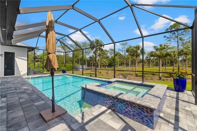 View of pool featuring glass enclosure, a pool wit