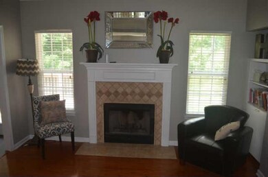 View of the fireplace in the living room - gas logs included, but also can burn wood