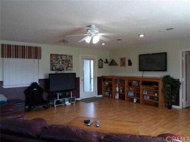 Game room features ceiling fan, built in oak buffe