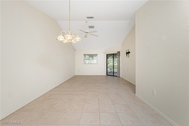 Unfurnished room featuring a chandelier, lofted ce