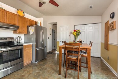 THE EATIN KITCHEN LOOKS OUT INTO FENCED IN BACK YA