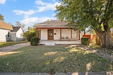 View of front facade featuring covered porch and a shingled roof