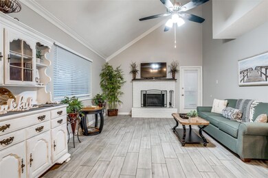 Living room with vaulted ceiling, a brick fireplac