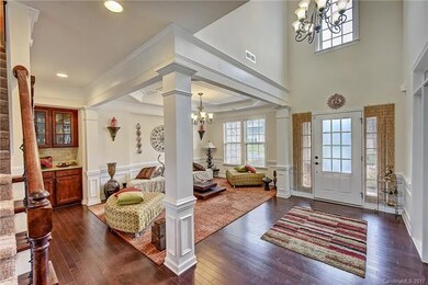 Bright foyer with lovely chandelier. Built in butl