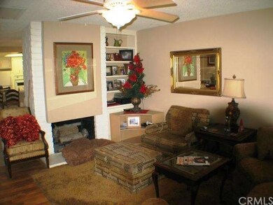 Living room with gas fireplace and ceiling fan