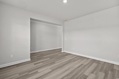 Spare room featuring baseboards, wood finished flo
